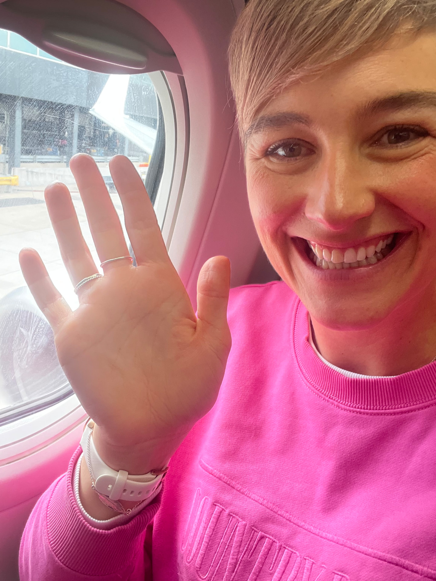Dominie smiling from a plane window seat